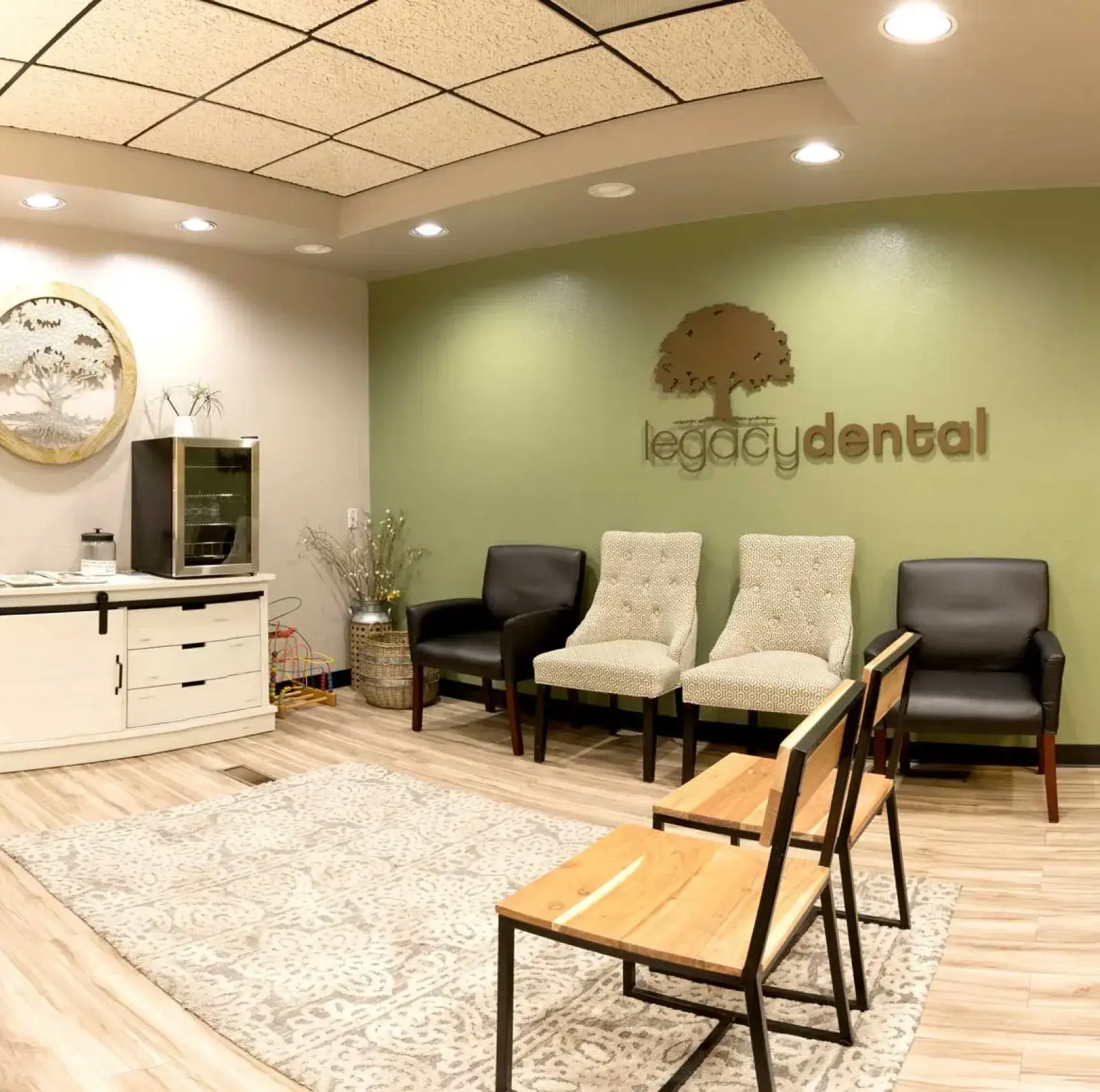 A waiting room with chairs and a television.